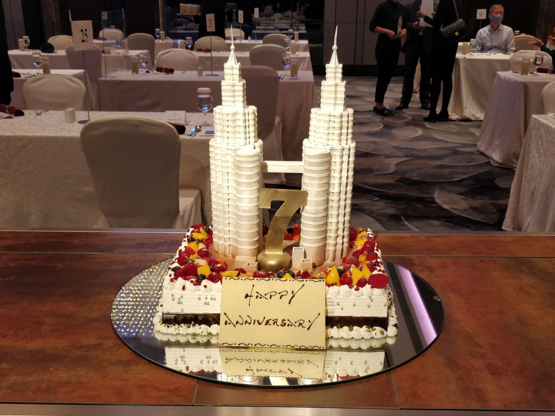An anniversary cake in the shape of the Petronas Twin Towers