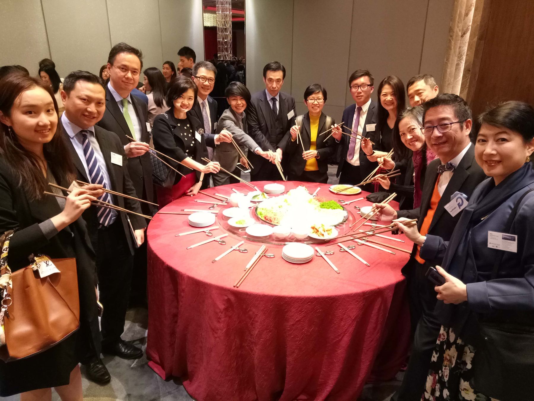 Guests tossing yusheng together at the ASEAN Chambers CNY Gathering 2019