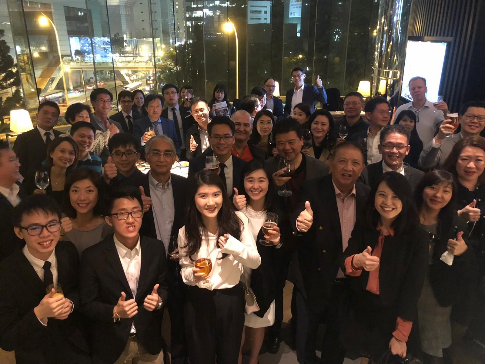 Members raising their glasses at the March Monthly Happy Hour