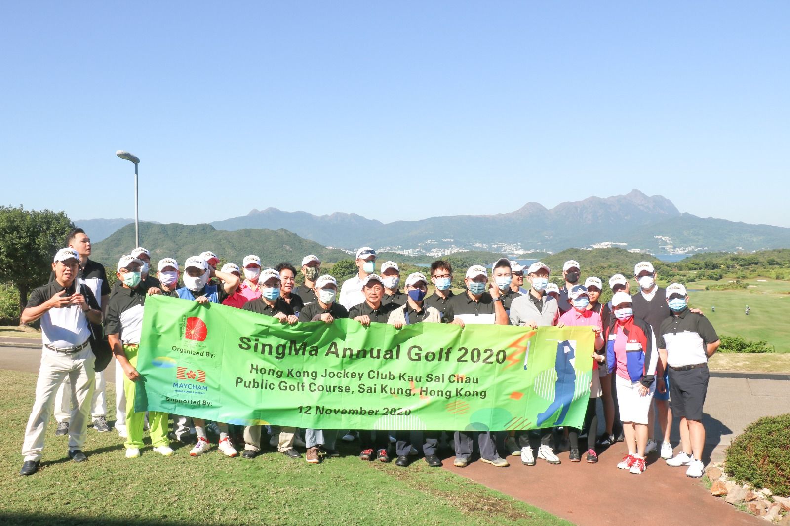 Golfers holding the SingMa Annual Golf 2020 banner on the Kau Sai Chau course in Sai Kung