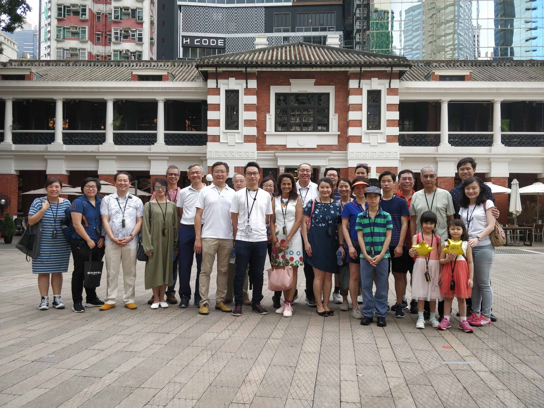 Members gathered in front of the heritage buildings at Tai Kwun